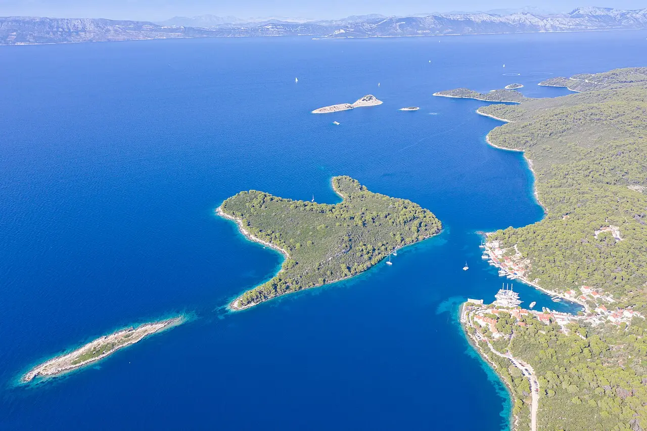 Aerial view of the small harbour of Pomena on Mljet with the islet of Pomeštak just offshore