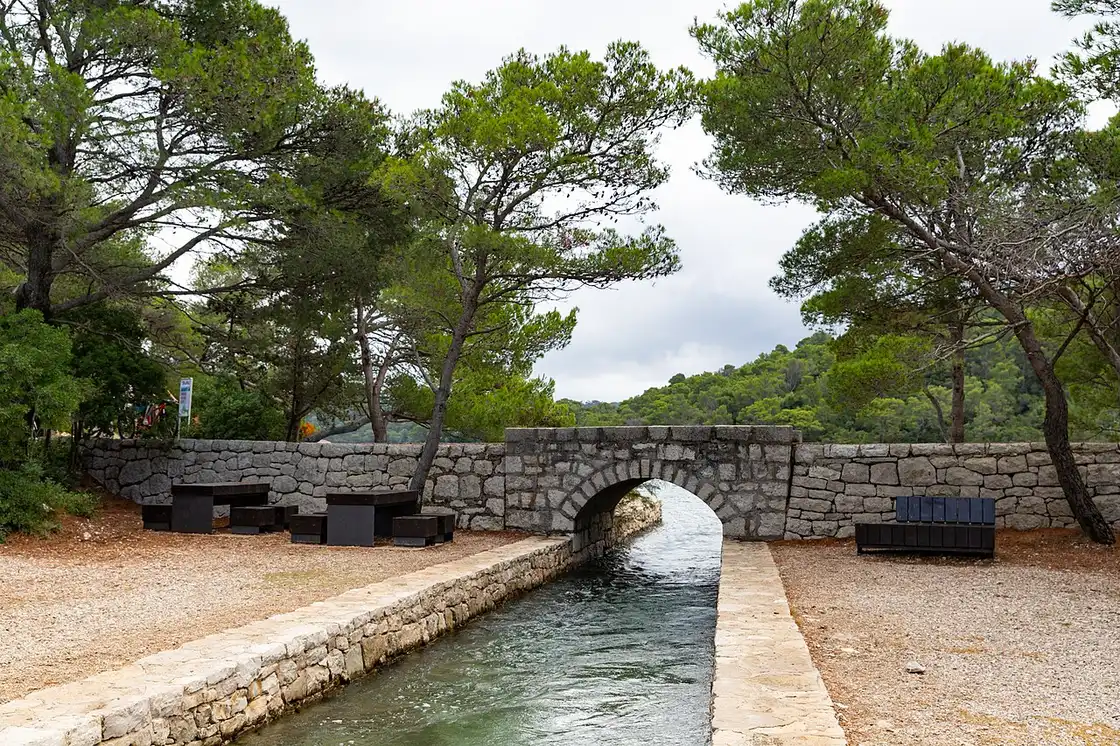 The narrow channel connecting Veliko Jezero and Malo Jezero on Mljet, seen from above with forest on both banks
