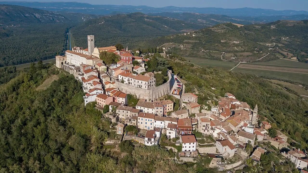 Aerial view of Motovun crowning a green hill above vineyards and the Mirna valley in inland Istria