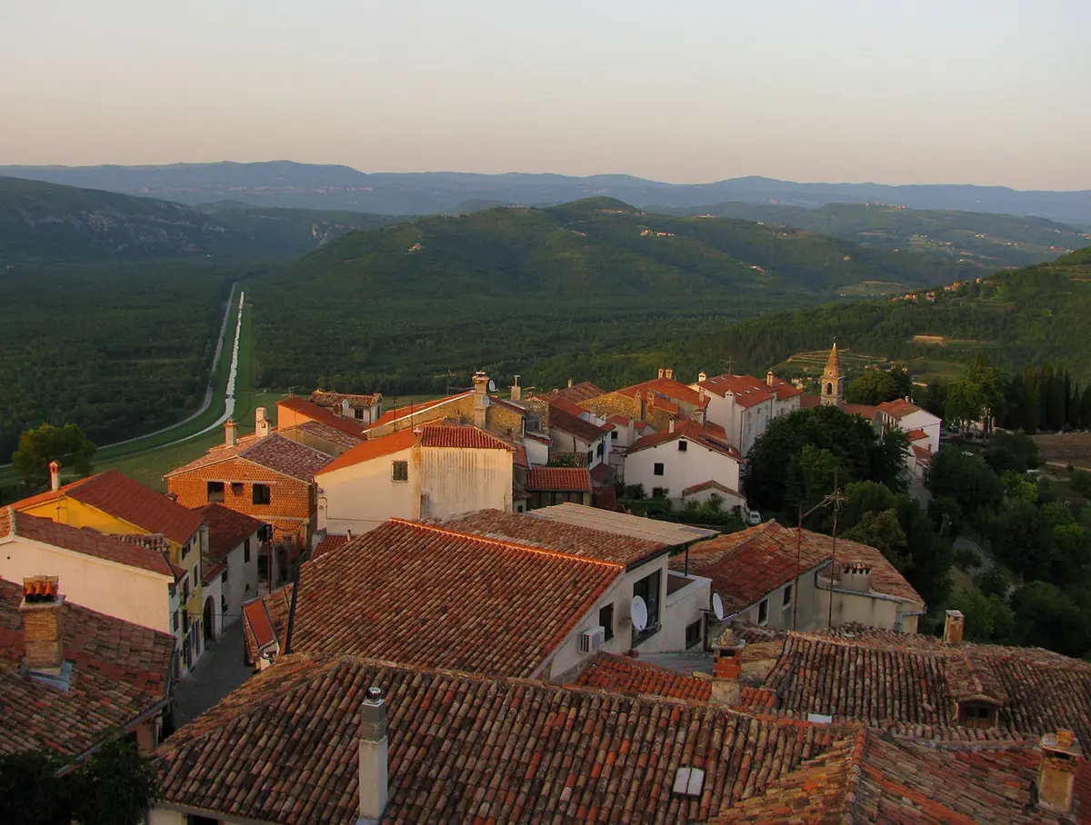 View from Motovun walls across terracotta roofs toward green Mirna valley hills