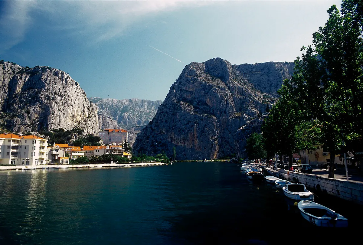 Lower Cetina canyon with river and road tucked under steep rock walls