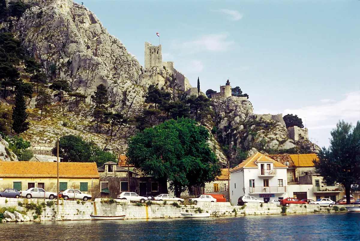 Mirabela Peovica fortress stone walls above Omiš with coastal hills behind