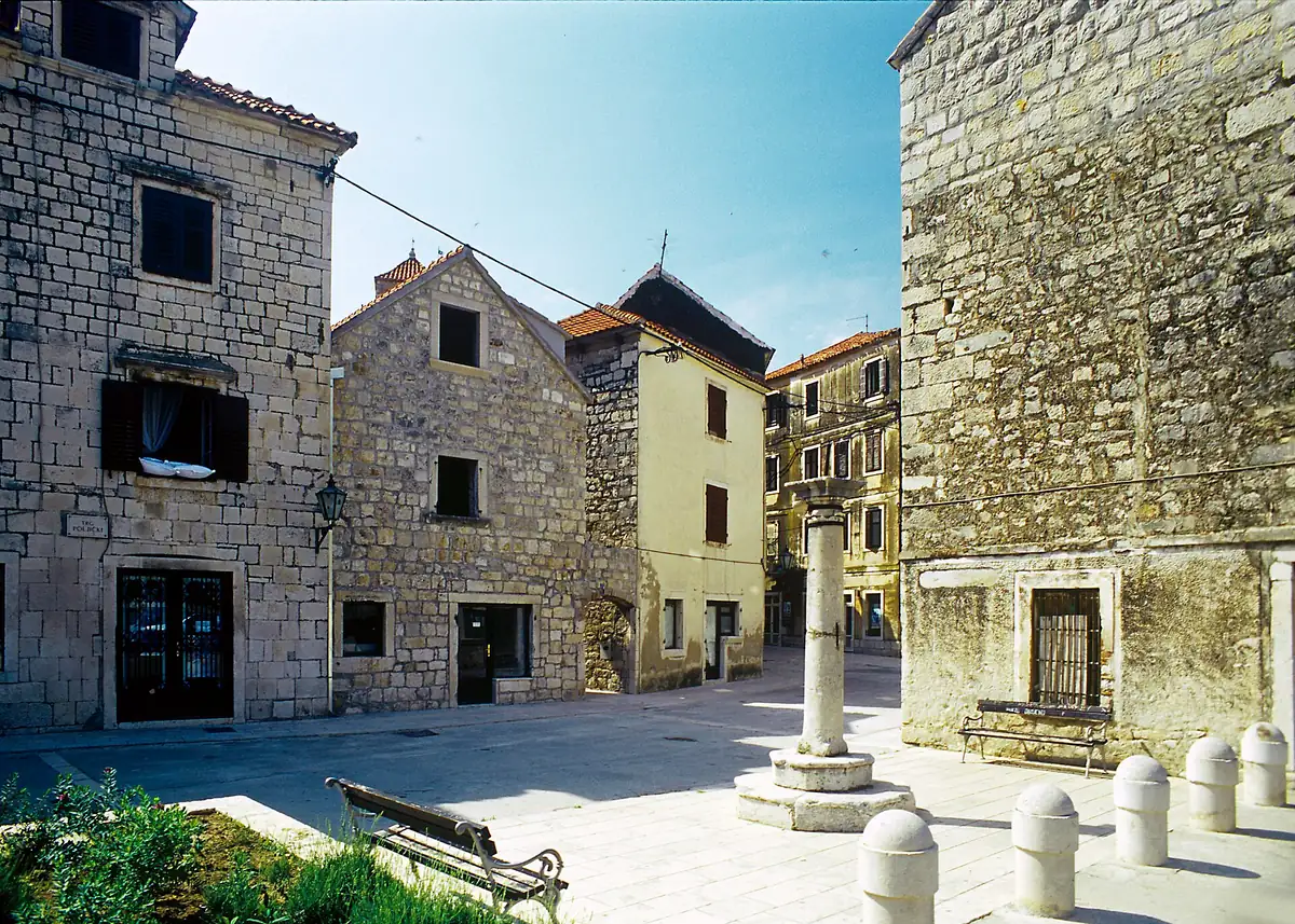 Stone buildings and outdoor seating on Poljički Square in Omiš old town