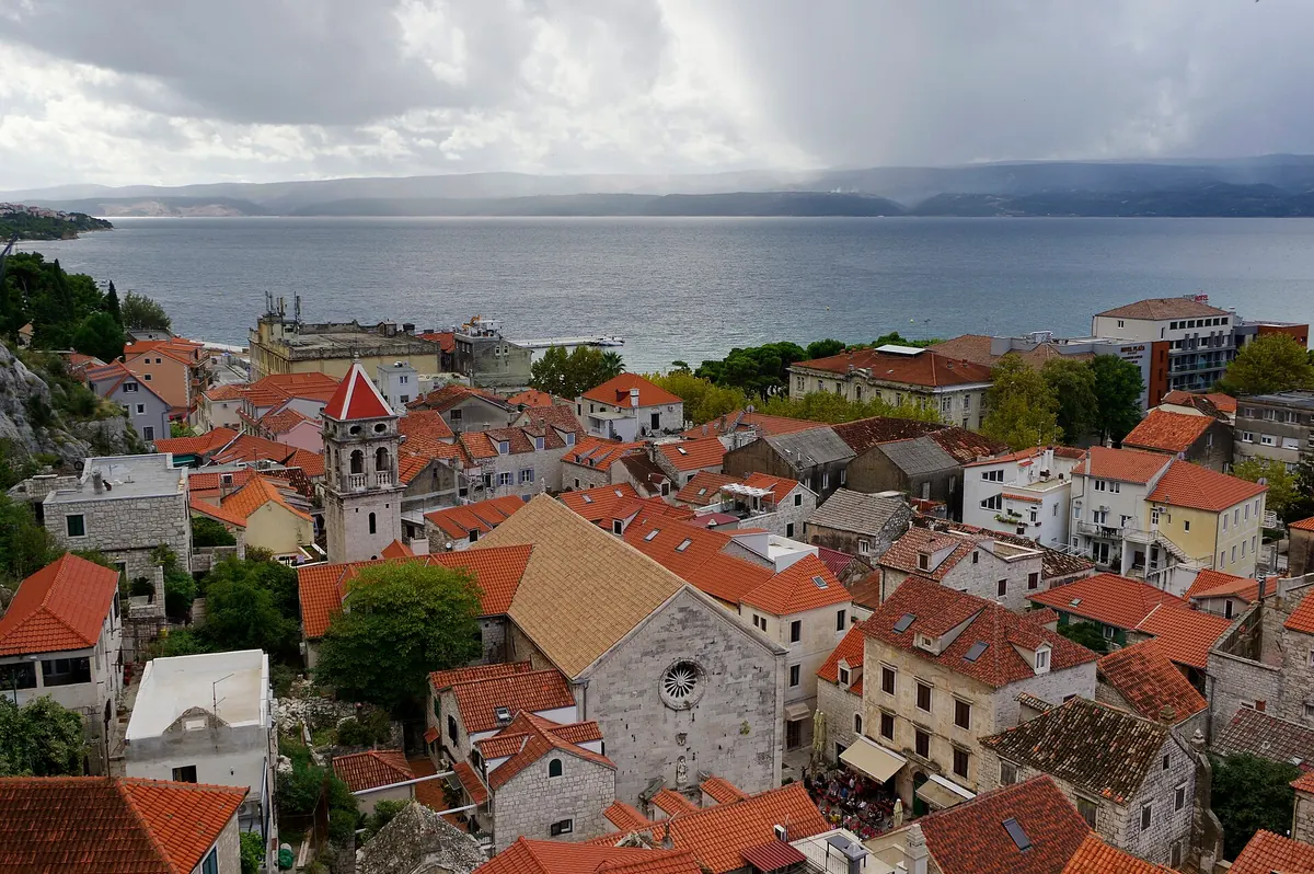 Steep stone lane climbing through Omiš old town toward the hillside forts