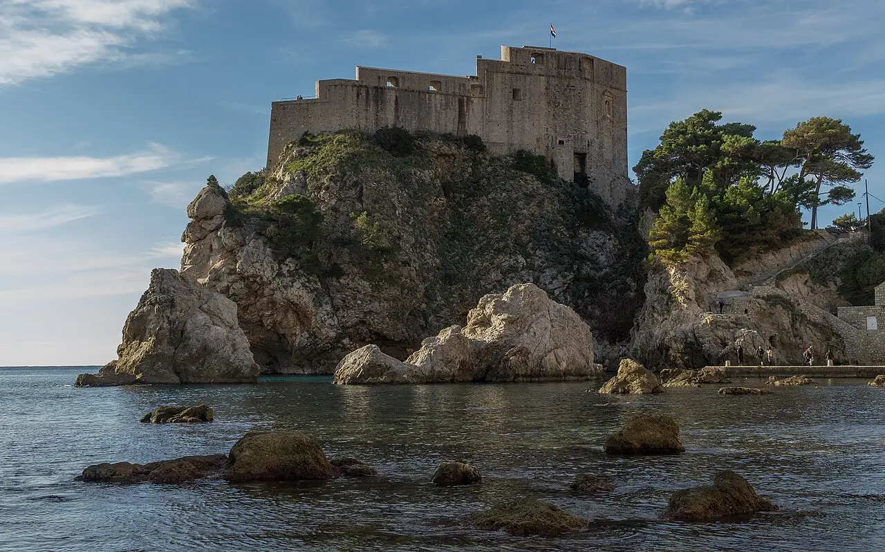Fort Lovrijenac rising on its rock above the sea beside the walls of Dubrovnik Old Town