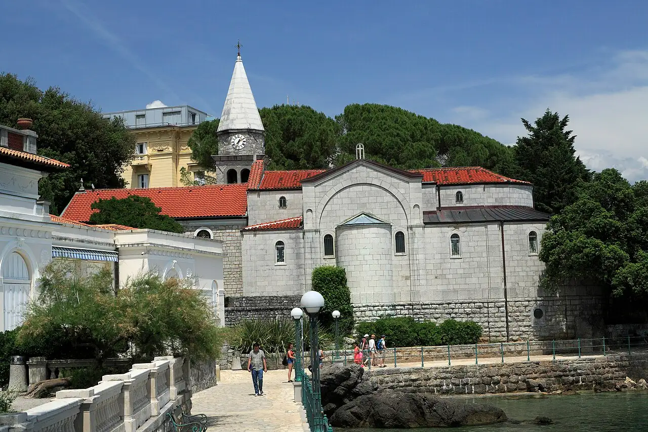 St Jacob's Church above the trees in Opatija with the Kvarner Gulf beyond