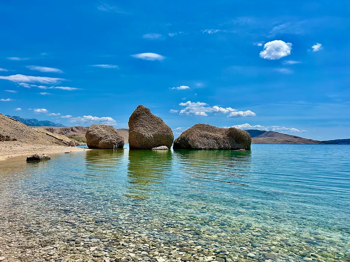 The rock formations standing in the sea at Beritnica cove near Metajna on Pag