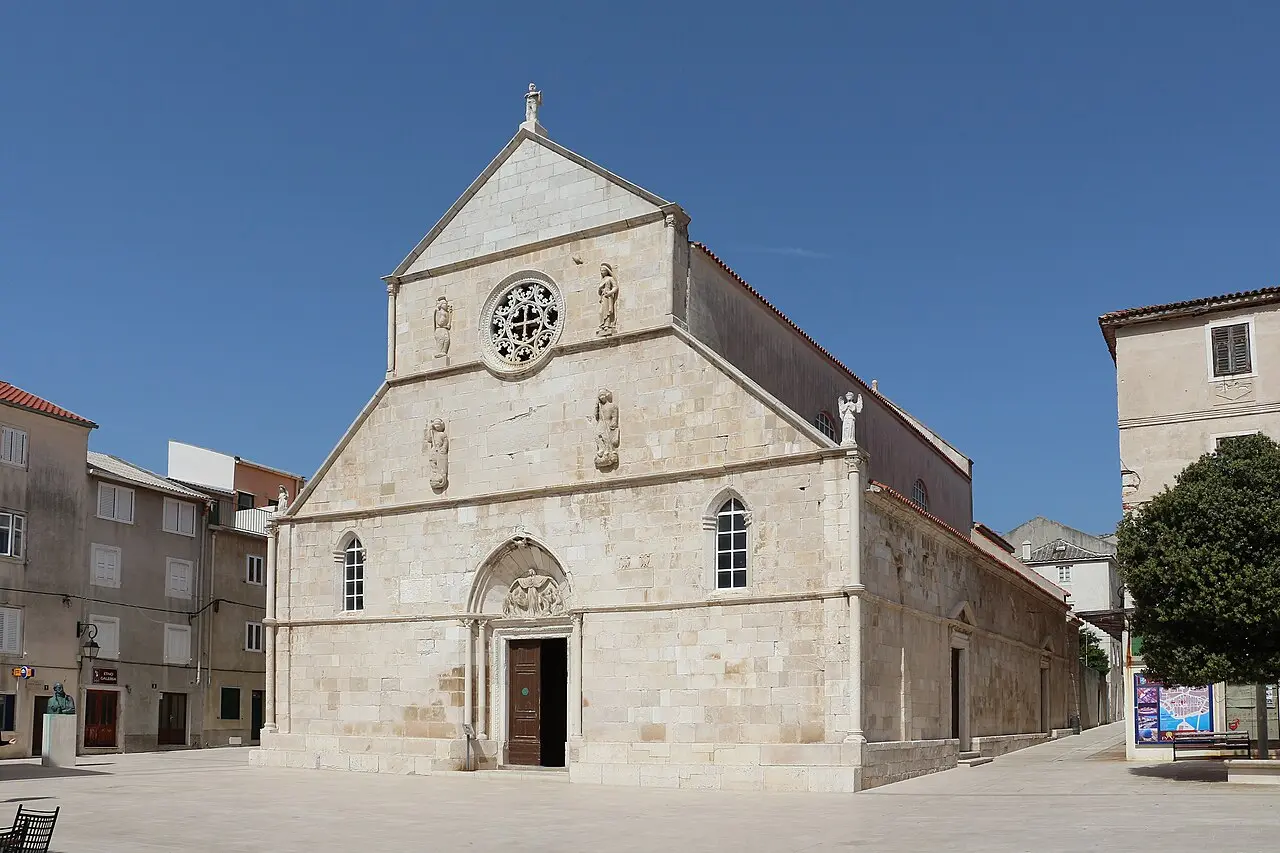 The stone west front and rose window of the collegiate church of the Assumption on the main square of Pag