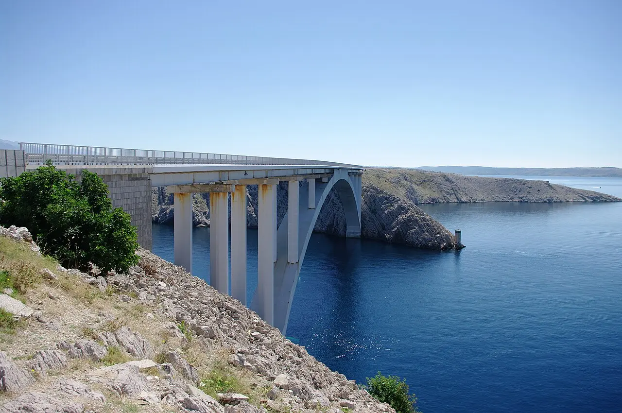 The single-arch Pag Bridge crossing the narrow strait between the mainland and the island of Pag