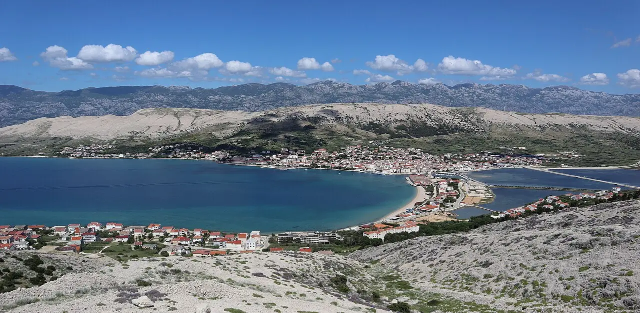 Panoramic view over the stone roofs of Pag town and its bay