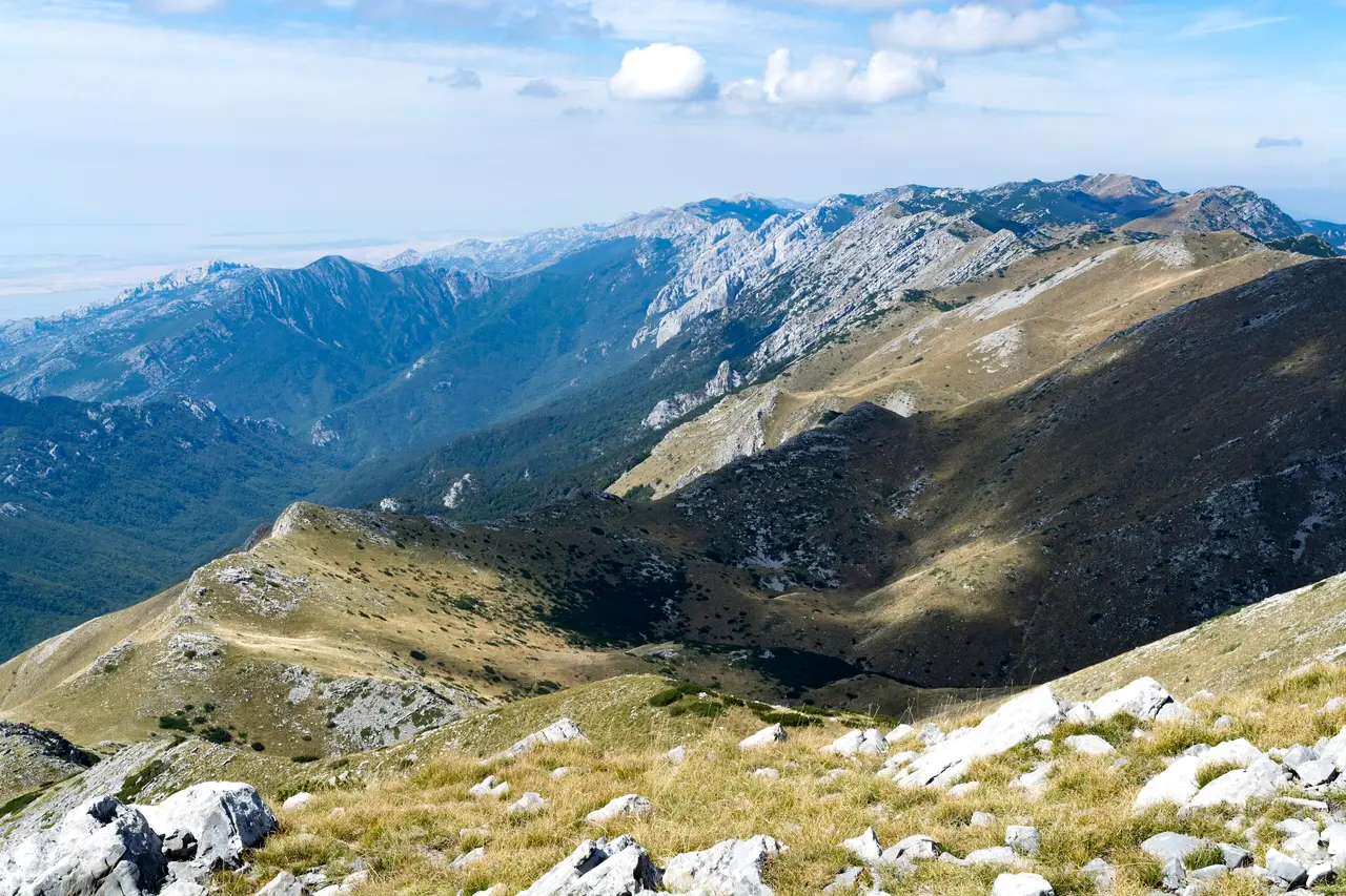 A high, wide view over the green ridgelines and karst peaks of the Velebit mountains from near the summit trail