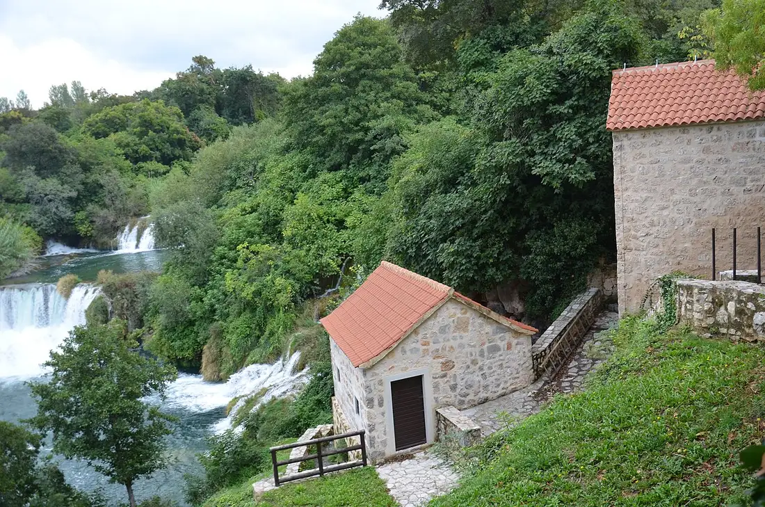 Skradinski Buk cascades beside stone watermill buildings at Krka