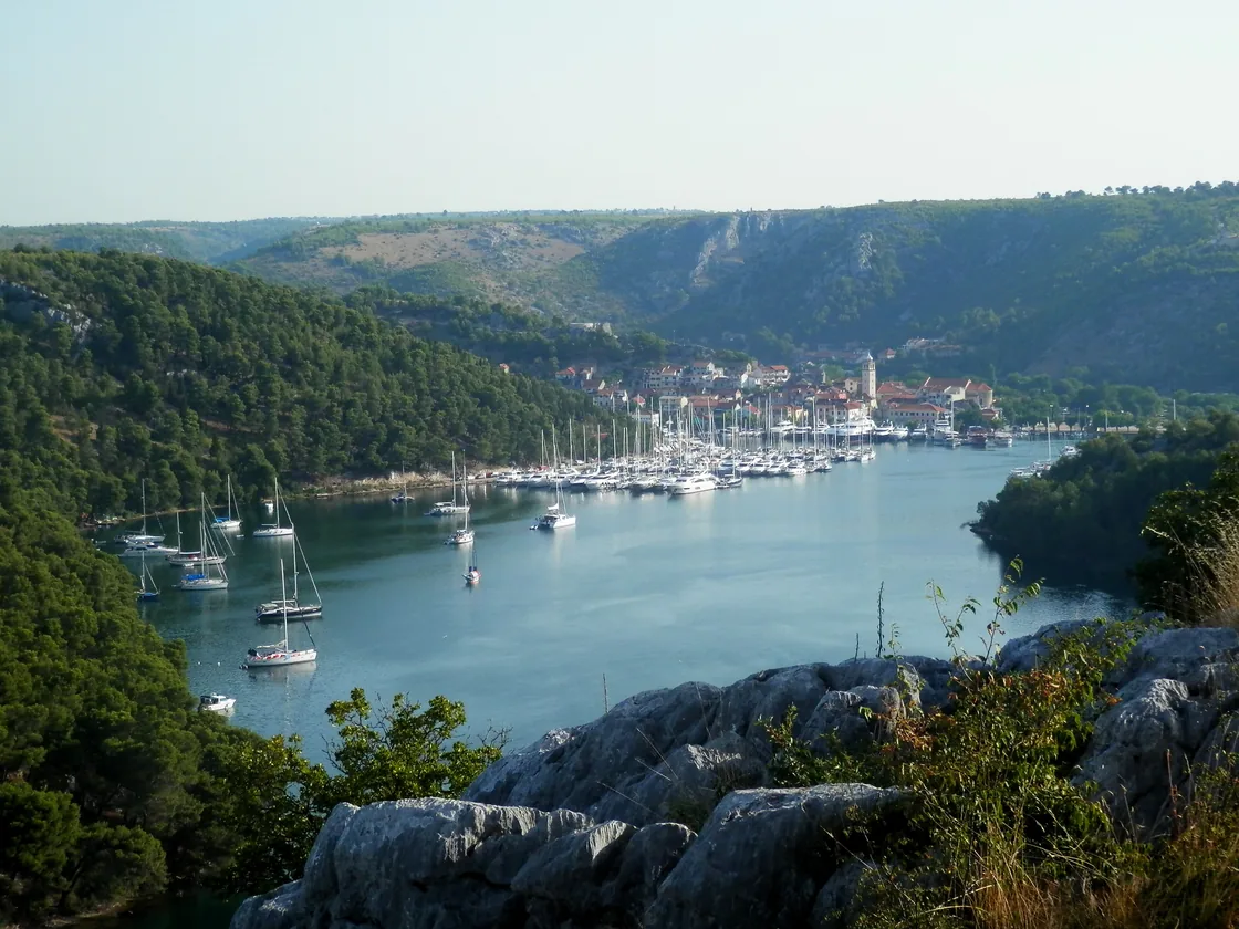 Yachts in the marina at Skradin with the town and the Krka canyon behind