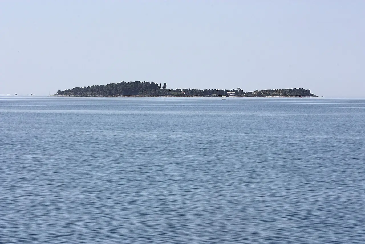 The wooded island of Veliki Brijun in the Brijuni archipelago seen across the sea from Fažana near Pula