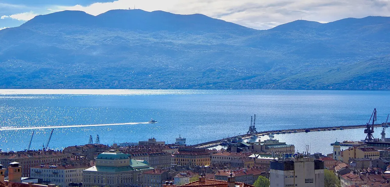 Rijeka centre and harbour with Mount Učka rising behind the bay