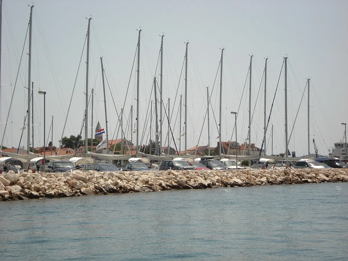 Charter sailboats rafted along a pontoon in a Dalmatian marina