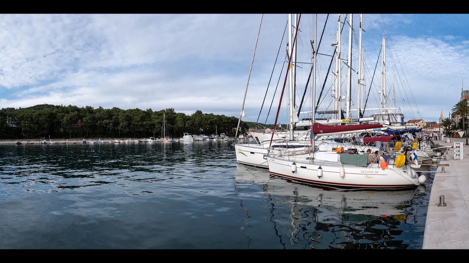 Sailing boats lined along the stone quay of Stari Grad harbour on Hvar island