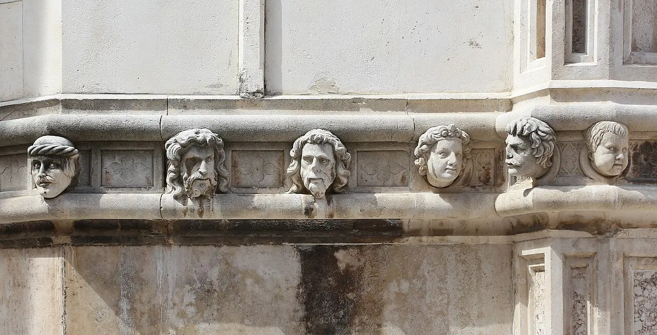 A frieze of realistically carved stone portrait heads running along the exterior apse of the cathedral of St James in Šibenik