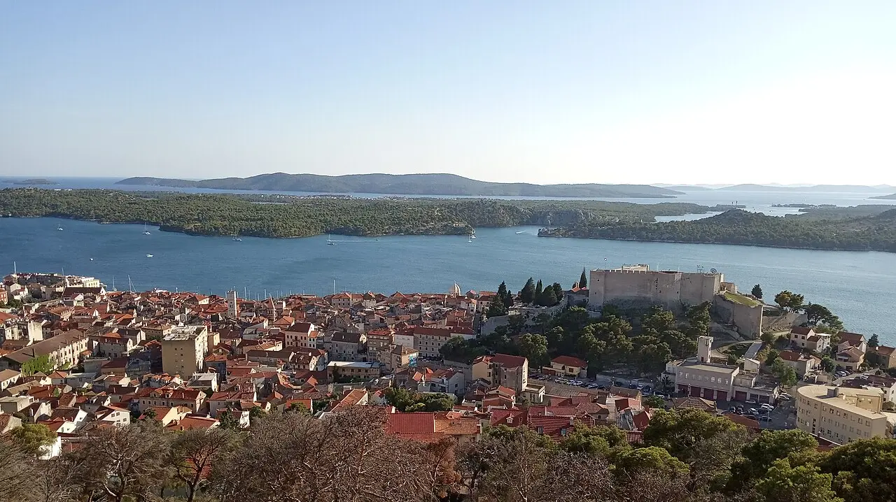 View over the terracotta rooftops of Šibenik old town, the St Michael fortress and the St Anthony channel with islands beyond