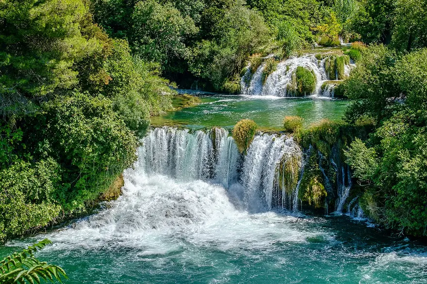 The Skradinski buk waterfalls in Krka National Park, wide travertine cascades falling into turquoise pools among green forest
