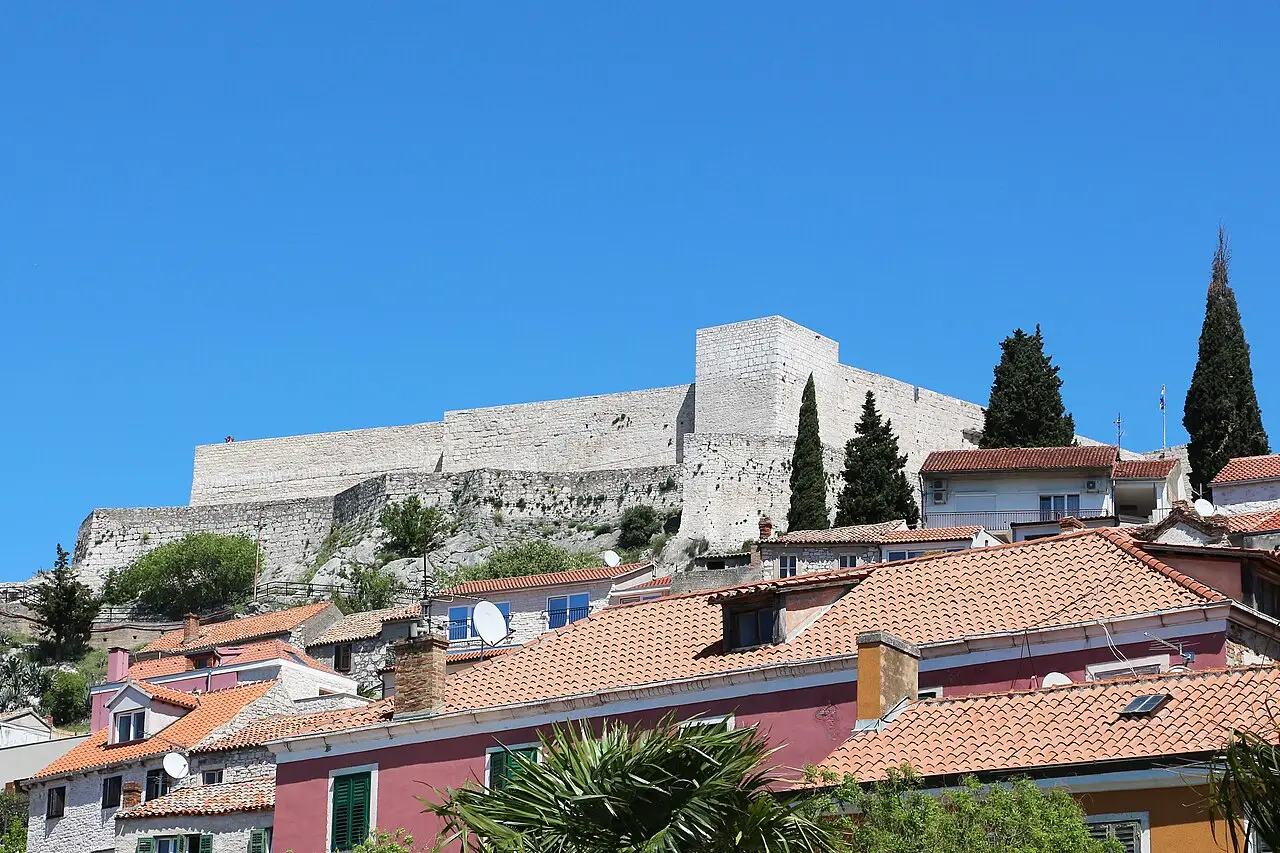 St Michael's Fortress on its hill above the terracotta rooftops and pastel houses of Šibenik old town