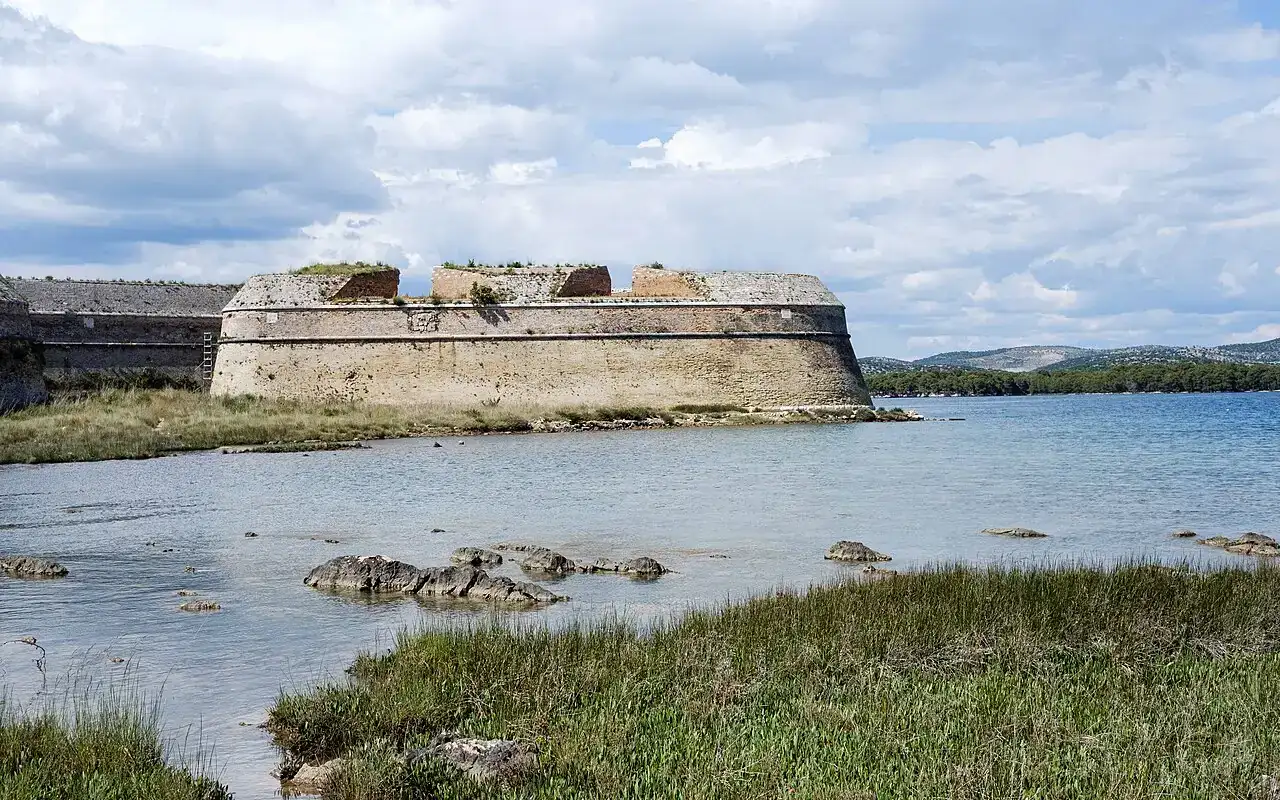 The low triangular St Nicholas sea-fortress standing in the water at the entrance to the St Anthony channel near Šibenik