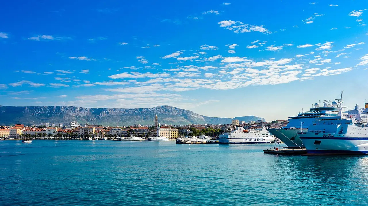 Split ferry port with a Jadrolinija ferry, the old town and mountains behind