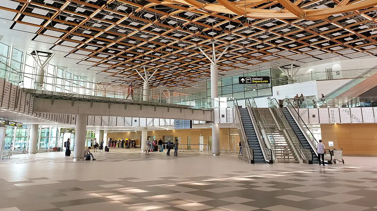 The bright modern interior of the new Split Airport terminal with a departures sign