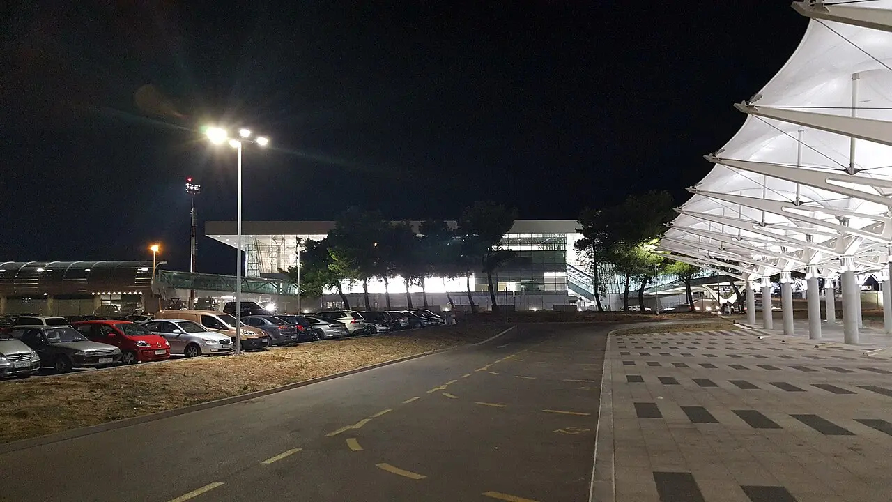 The forecourt and car park outside Split Airport terminal in the evening
