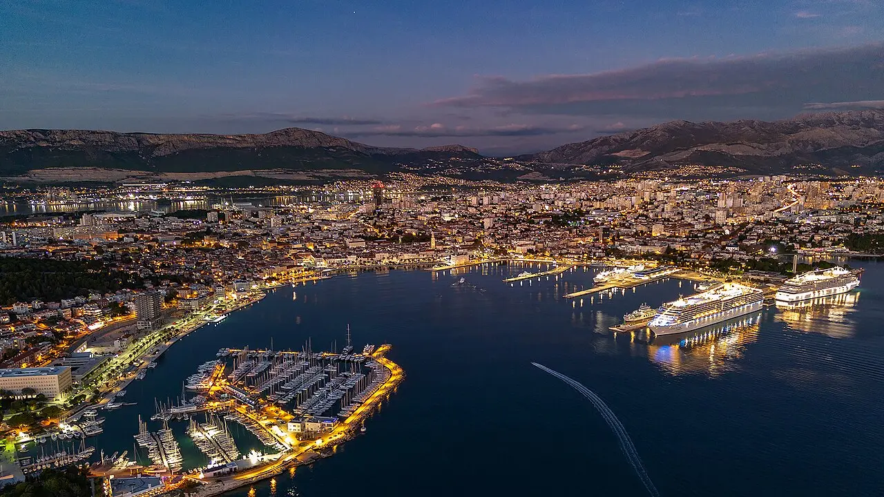 Aerial view of Split harbour and the old town lit up at dusk, the start of the night out