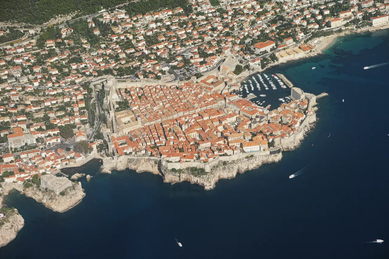 The walled Old Town of Dubrovnik on its headland above the Adriatic, seen from the sea