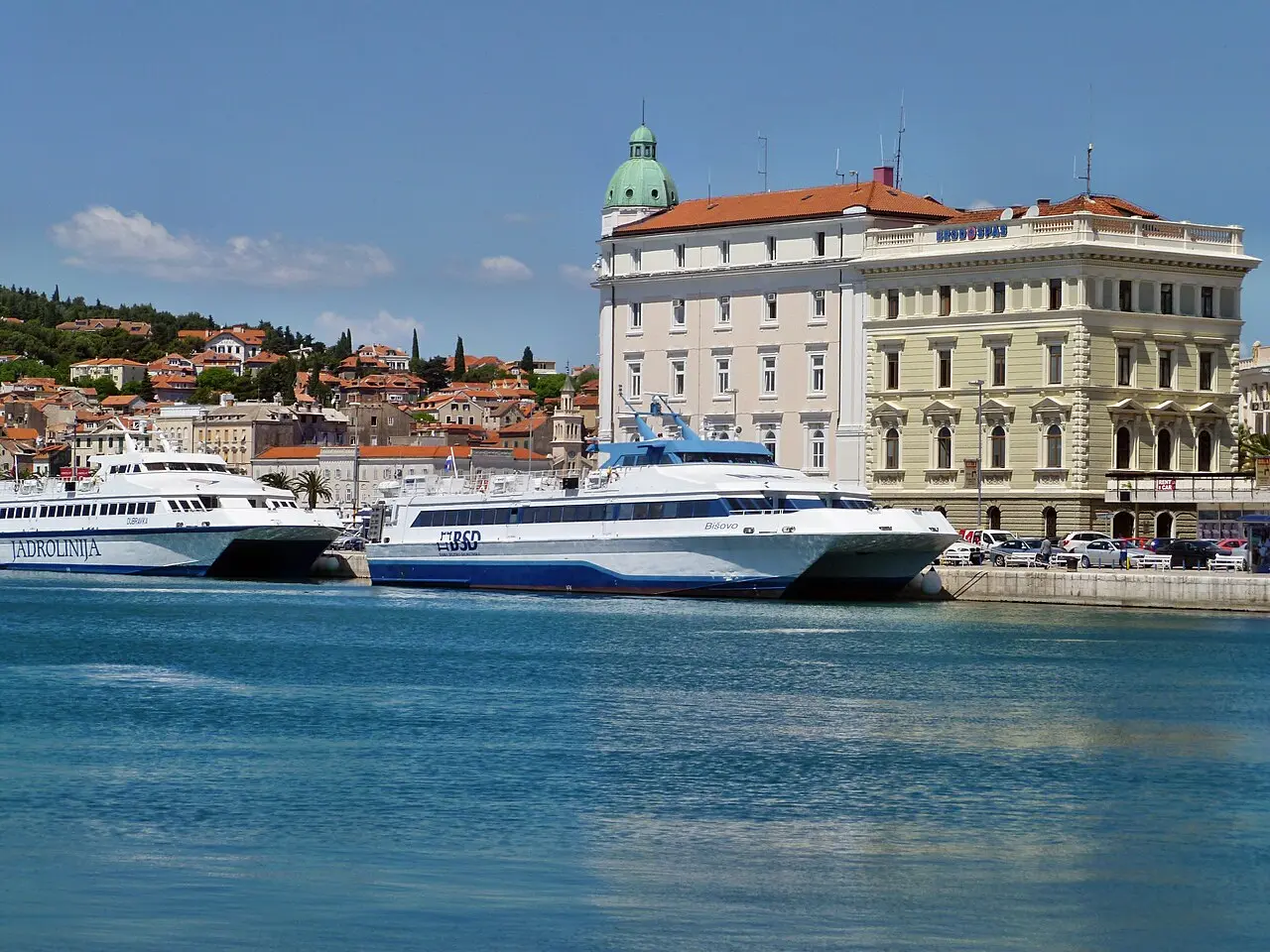 Split harbour with boats moored along the waterfront and the city hillside behind