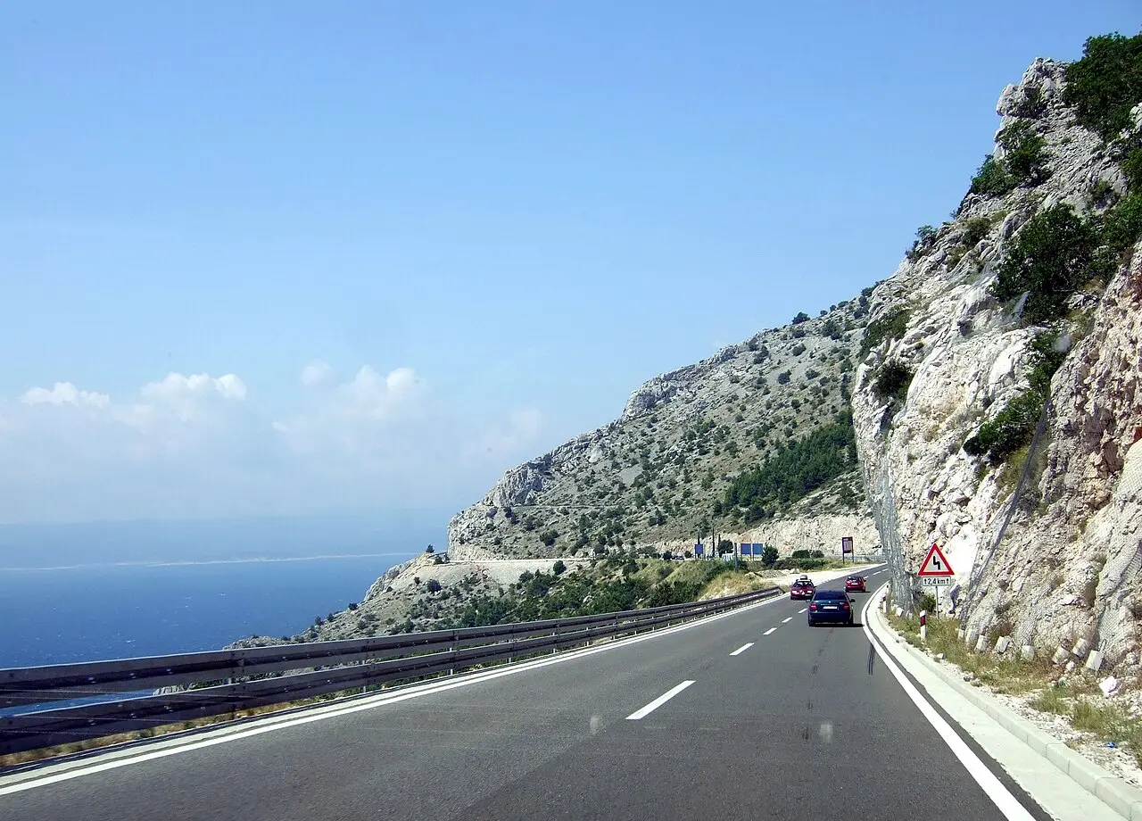The Adriatic coastal road (the old Magistrala, D8) hugging the cliffs above the blue sea