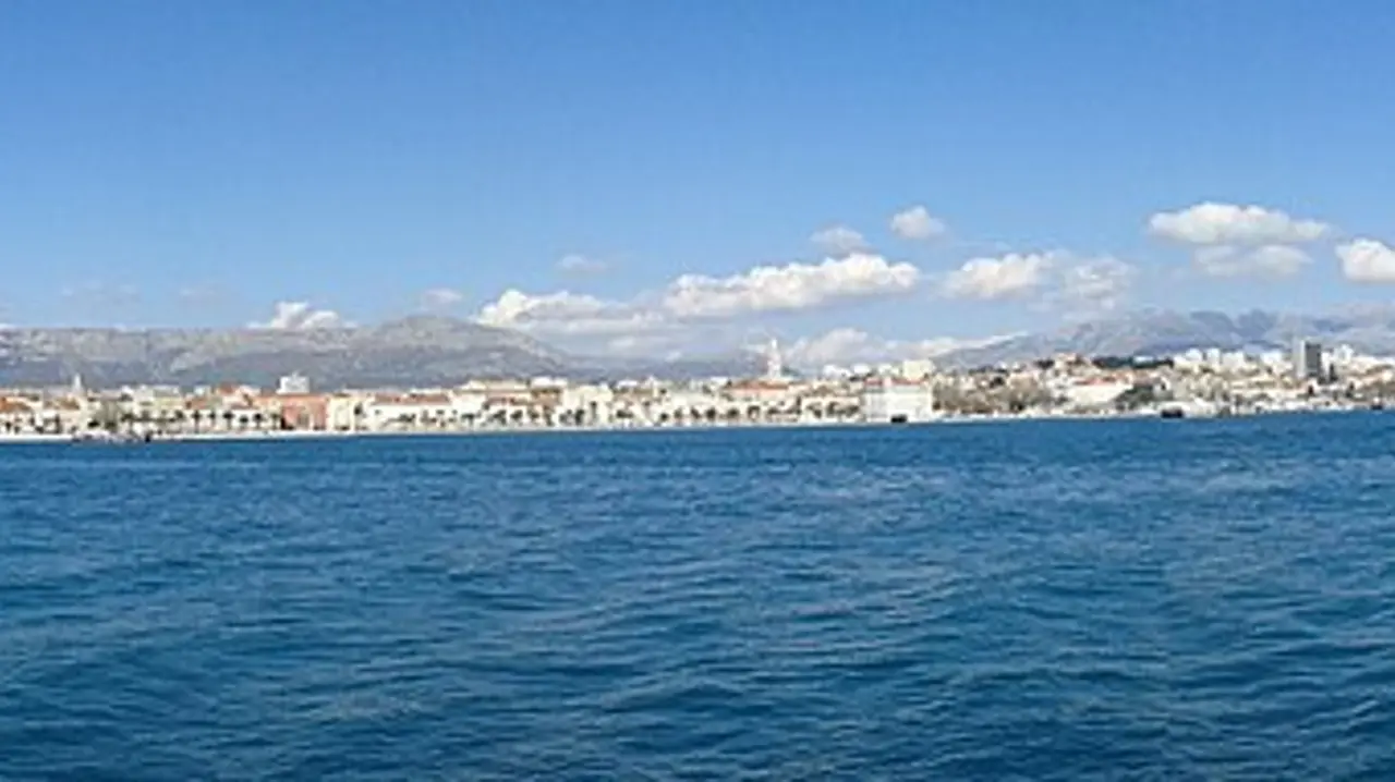 The waterfront of Split seen from the sea, with the old town and harbour below the hills