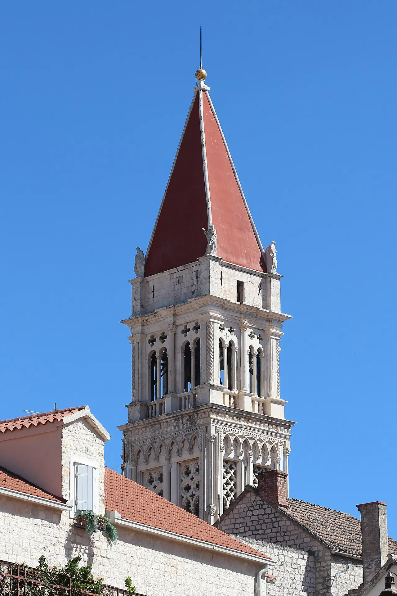 The tall Venetian-Gothic bell tower of the cathedral of St Lawrence rising over the stone rooftops of Trogir