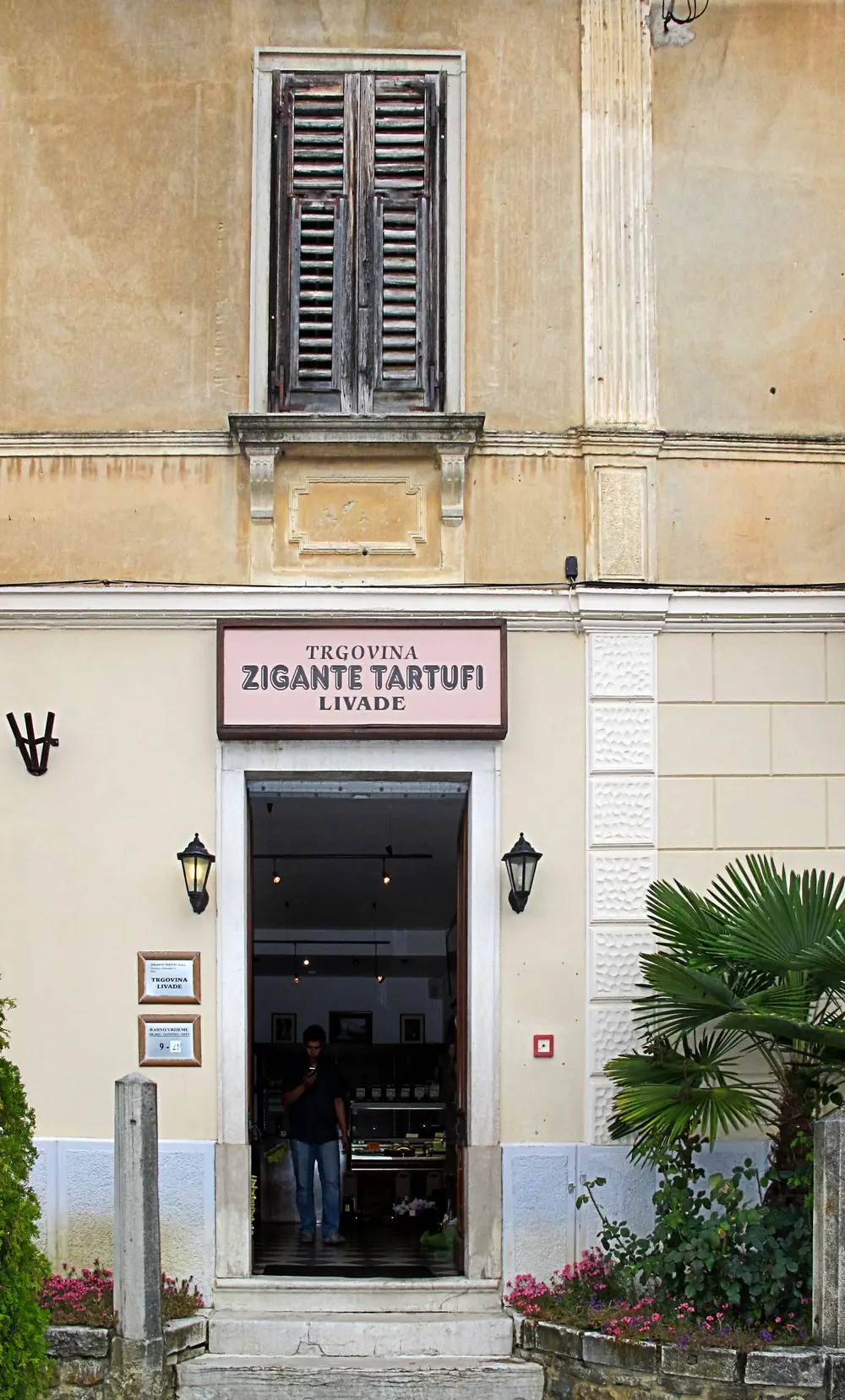 The pale facade and open doorway of the Zigante Tartufi shop in the village of Livade, Istria