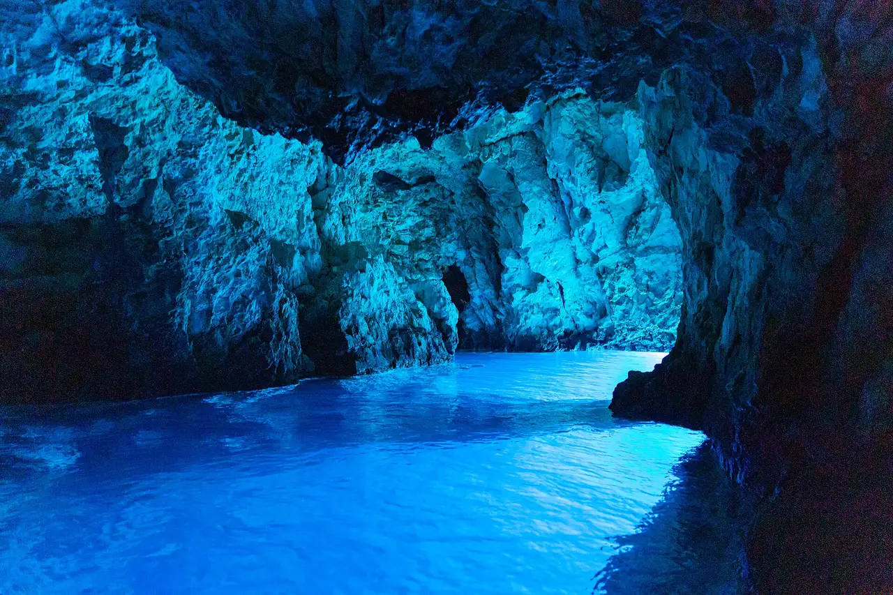 The interior of the Blue Cave on Biševo glowing bright blue, with the water lit from below