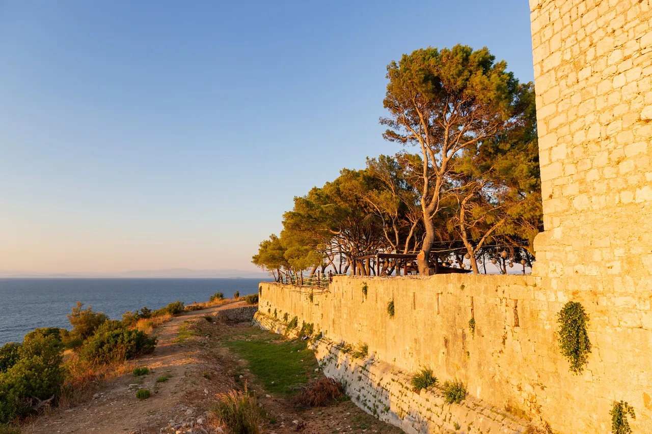 Fort George on a headland above Vis, a low stone fortress overlooking the blue Adriatic