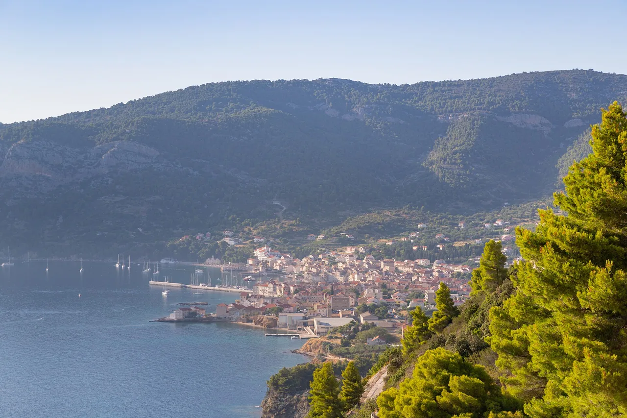 The rocky Adriatic coast below Komiža on Vis with clear turquoise water and pine slopes