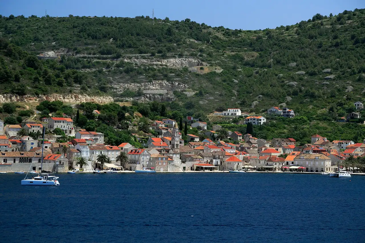 A quiet stone lane in the Kut quarter of Vis town, lined with old houses and shuttered windows