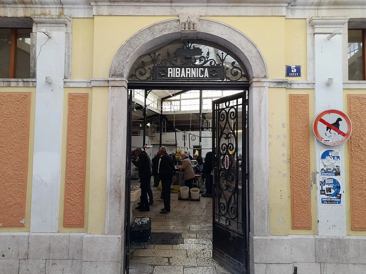 The wrought-iron entrance to the Split fish market with a Ribarnica sign above the door