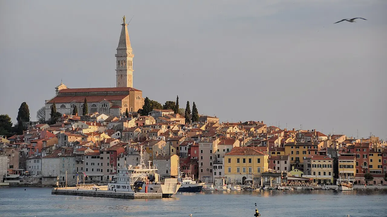 Sunrise over the old town of Rovinj on the Istrian coast, church tower above terracotta roofs and the Adriatic