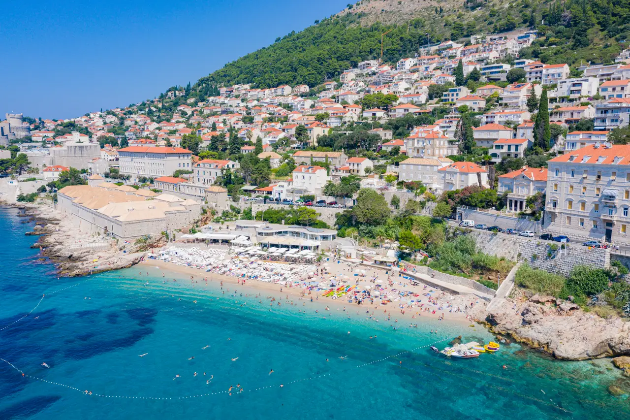 Banje beach below the Ploče side of Dubrovnik, with the Old Town walls behind