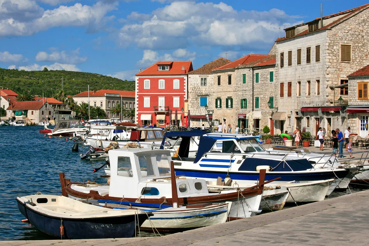 The sheltered old harbour of Stari Grad on Hvar with moored boats and stone houses