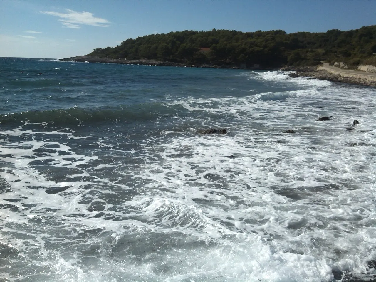 The sandy beach at Pržina near Lumbarda with shallow water and a few bathers