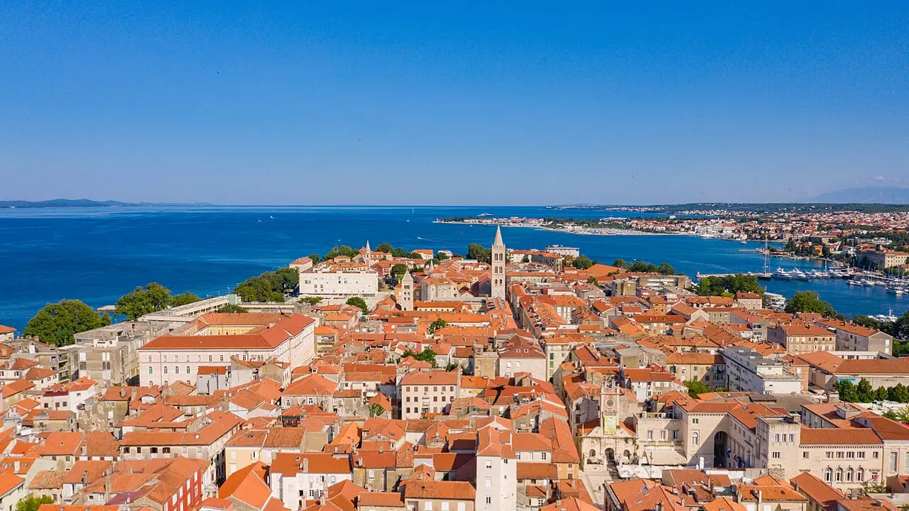 Aerial view of Zadar old town peninsula with terracotta roofs meeting the Adriatic