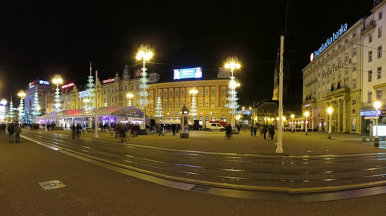 Wide view of Ban Jelačić Square in central Zagreb with trams and the equestrian statue
