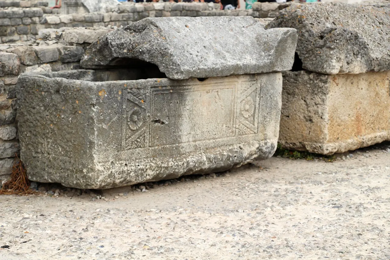 Scattered Roman columns and carved stone blocks of the Zadar Forum with the church behind