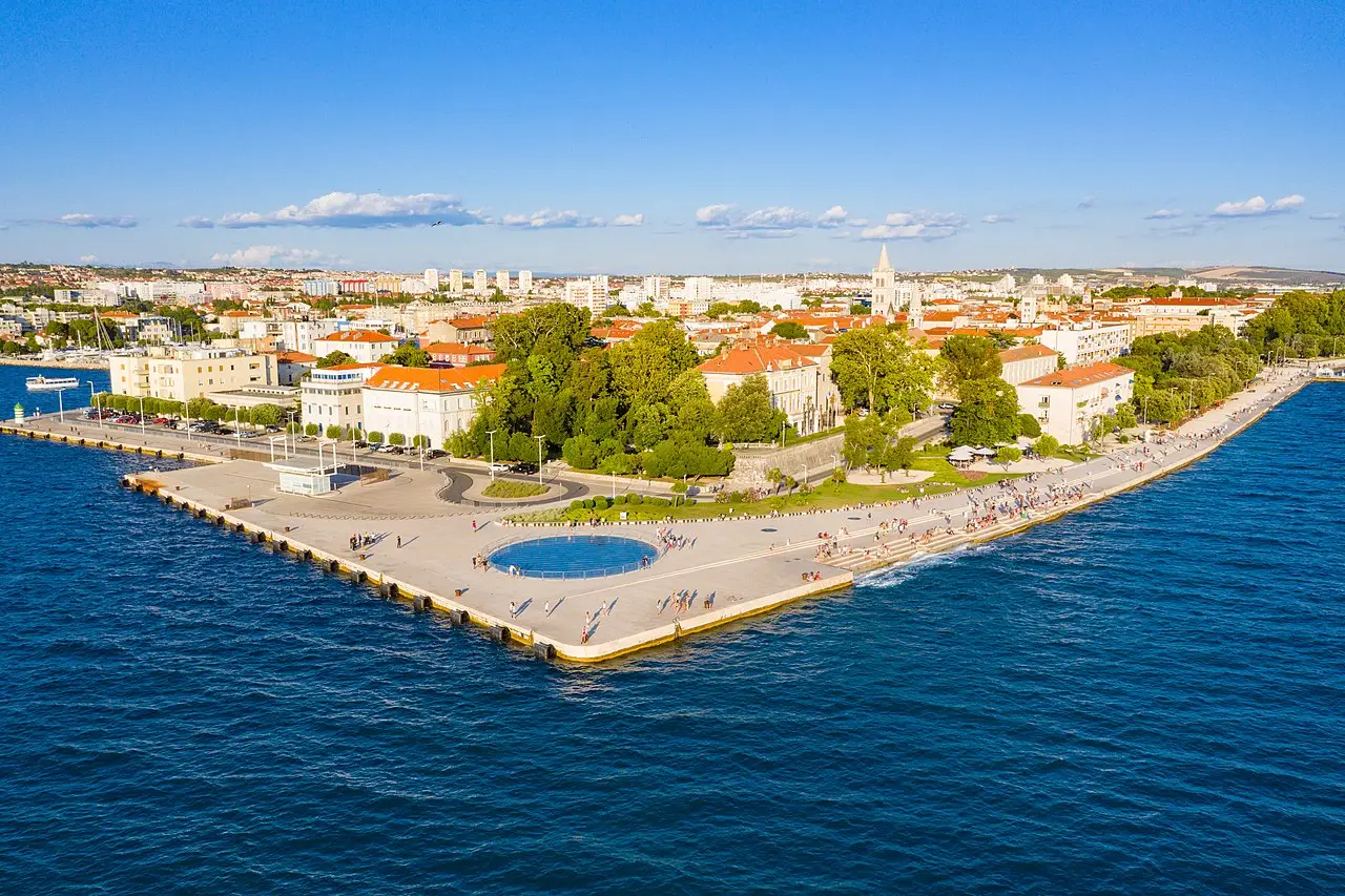 The large circular glass solar disc of the Greeting to the Sun set into the Zadar waterfront pavement by day