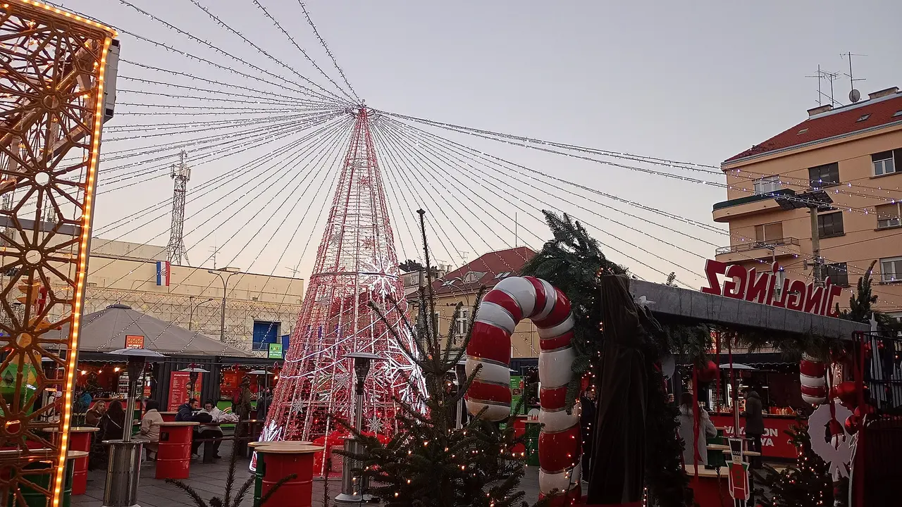A lit cone-shaped tree and candy cane decorations at the neighbourhood Advent market on Kvaternik Square in Zagreb